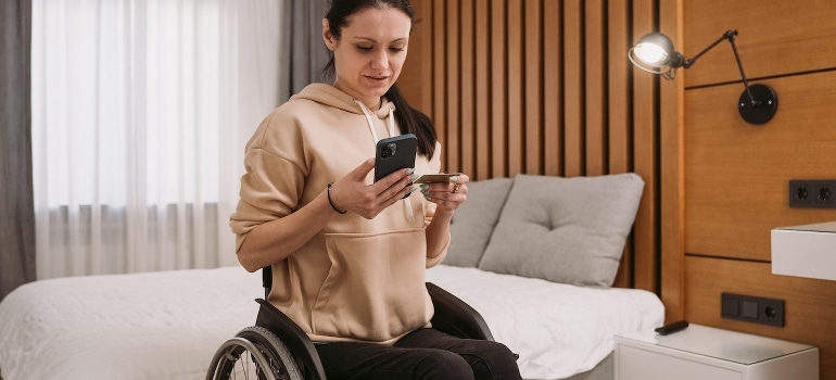 A woman in a wheelchair using her mobile phone