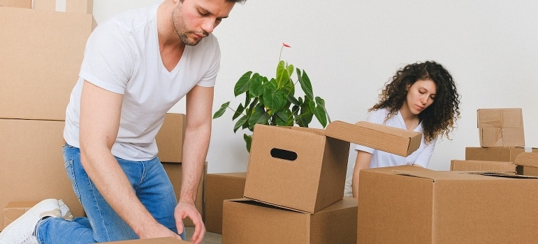 A man and woman packing boxes