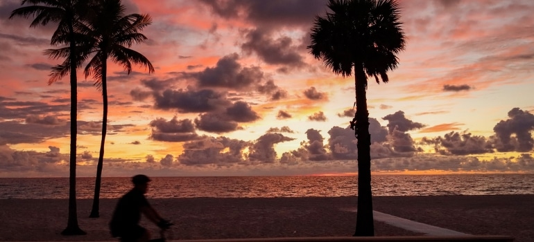 A man riding a bike and thinking about the pros and cons of moving to Florida