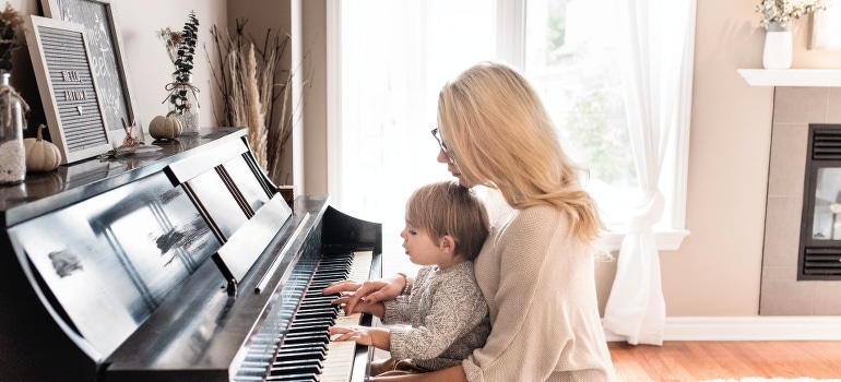 A woman and child playing piano