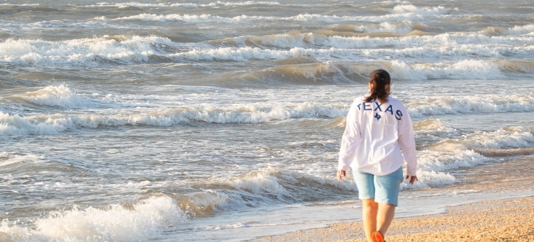 A woman walking by the beach