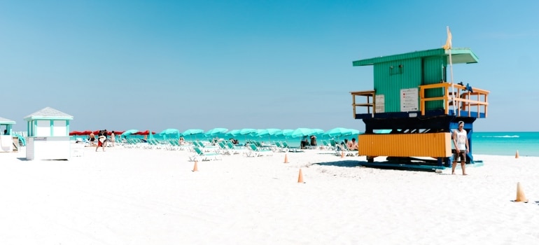 Green and orange lifeguard house on the beach