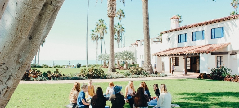 A group of people sitting on the ground