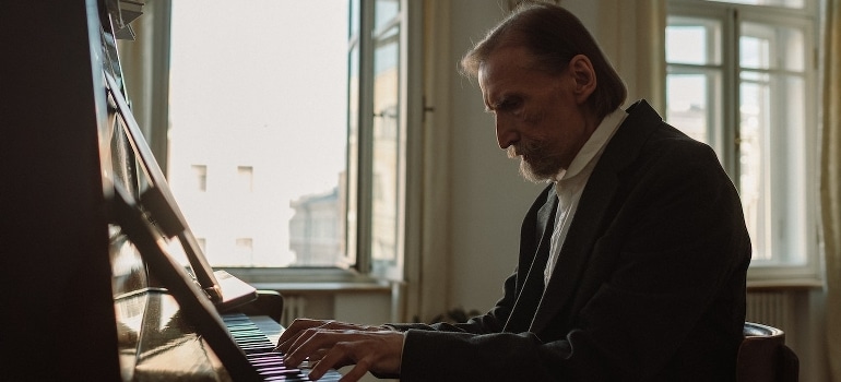 An elderly man playing piano