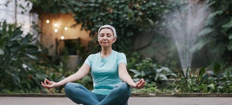 A senior woman doing yoga which is one of the best senior activities in Boca Raton.