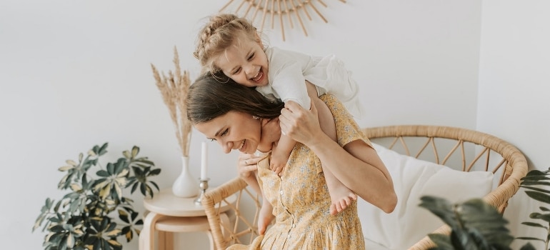 A woman hugging her baby daughter