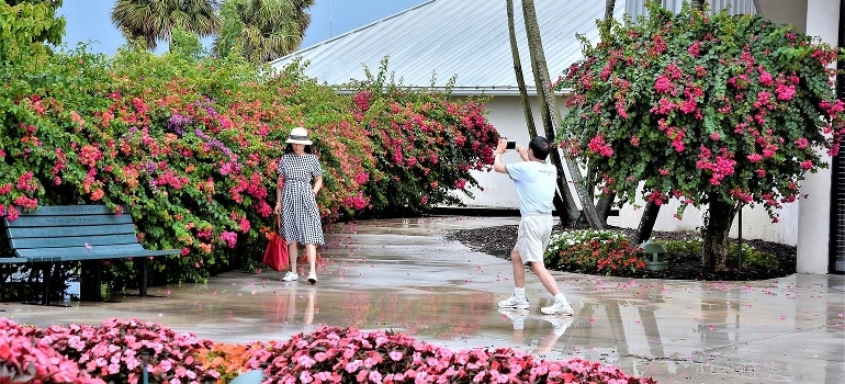 A man taking a photo of a woman - one of the things to do in Pompano Beach when exploring the city