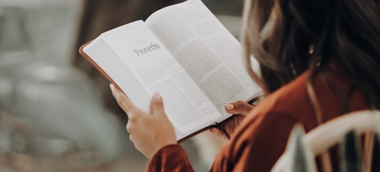 A child holding a book in one of the best places for moving with your family