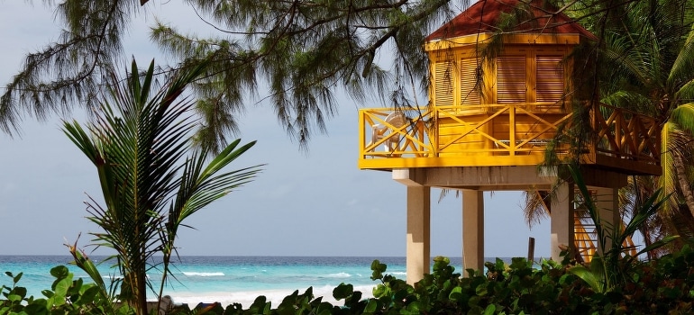 A yellow lifeguard station by the beach.