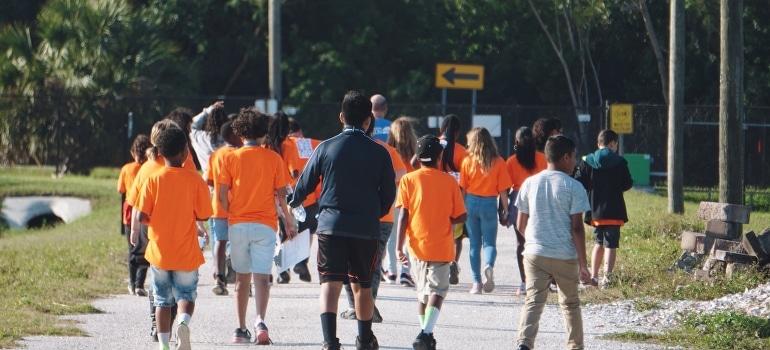 A group of students running after moving from Fort Lauderdale to West Palm Beach