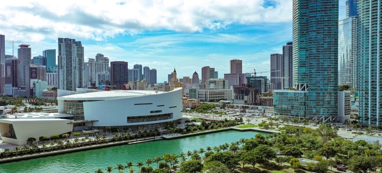 Taking a look at high-rise buildings near green trees is one of the ways to deal with stress when moving to Miami