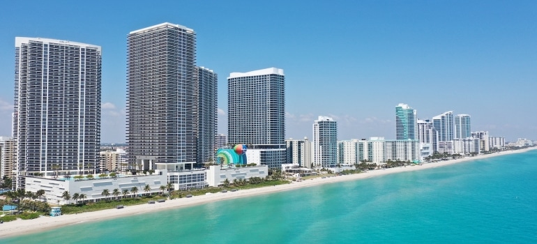 Modern high-rise buildings near a turquoise body of water