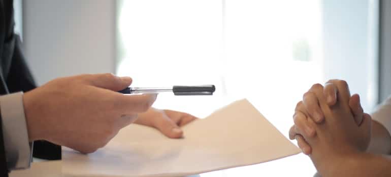 Two people signing a contract