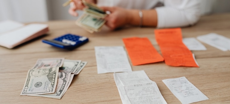 A person counting money to pay bills