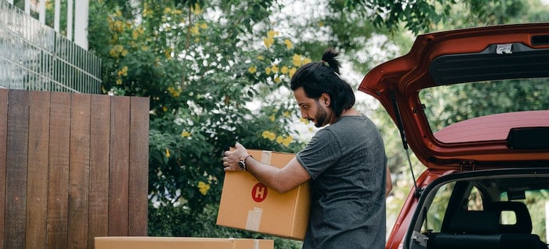 A man holding a moving box