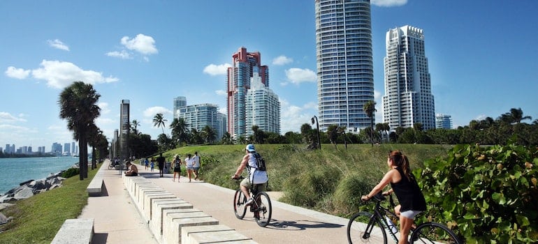 People riding the bike near the water