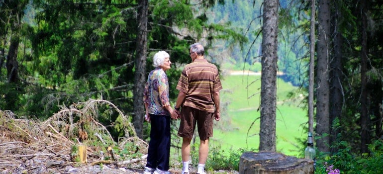 Two seniors standing in a park
