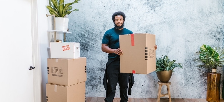 A man holding a cardboard box. 