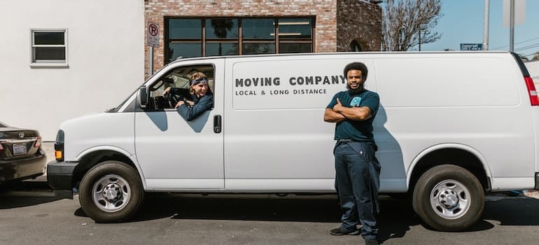 A mover standing in front of the moving van