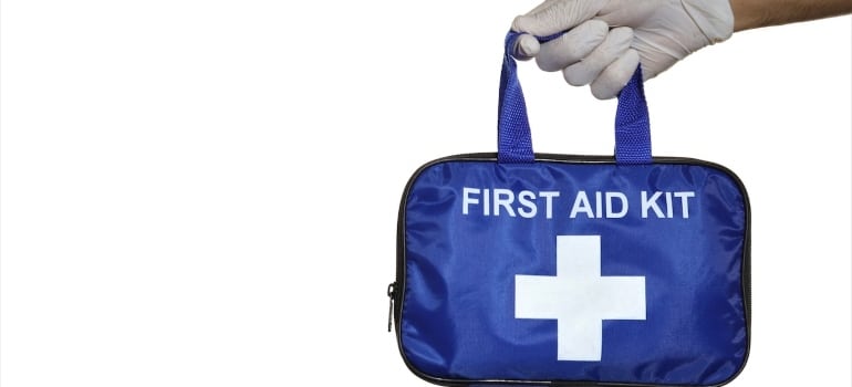 A blue first aid kit as one of the safety measures when dealing with extra heavy items