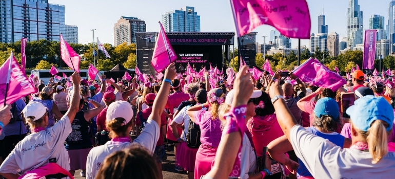 A large group of people with pink flags.