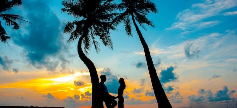 A couple on the beach during sunrise