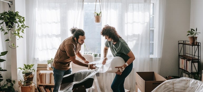 A couple packing a living room