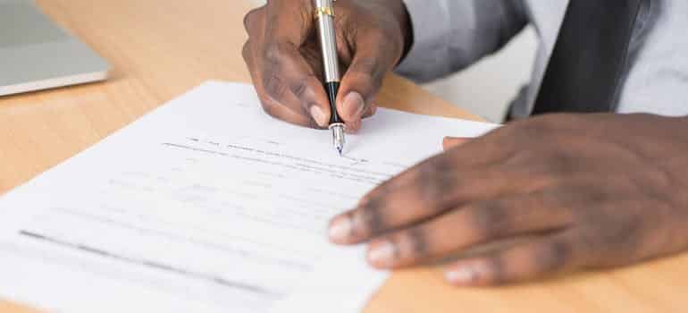 A person signing a contract 