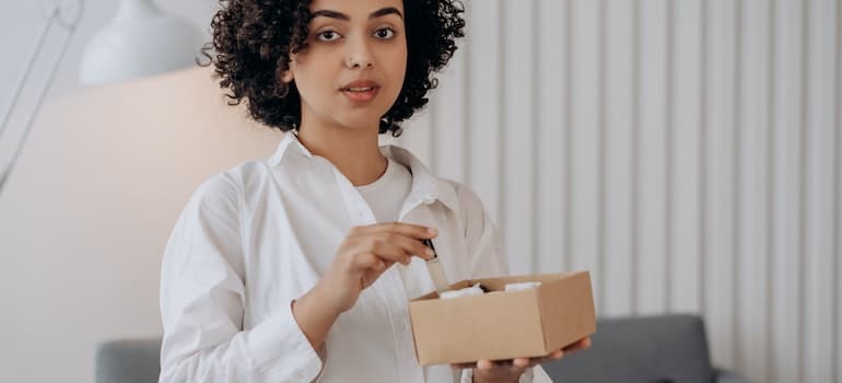 A woman holding a box