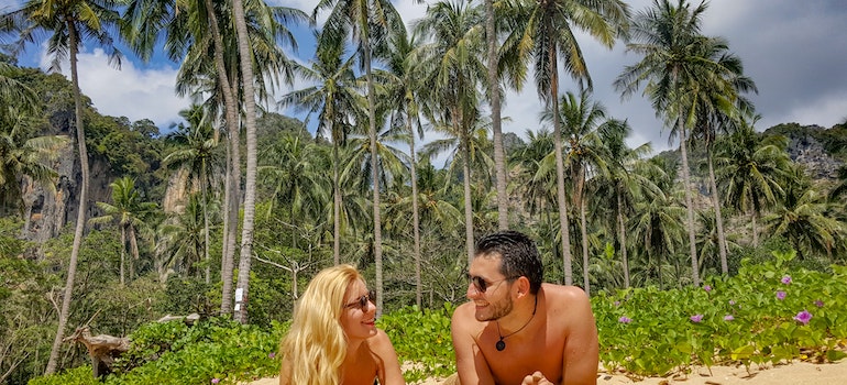 A couple lying on the sand 