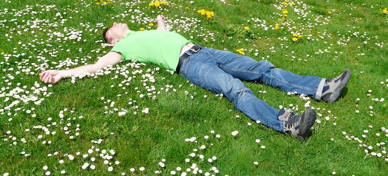 A person lying on the grass in one of the places in Florida that promote a healthy lifestyle