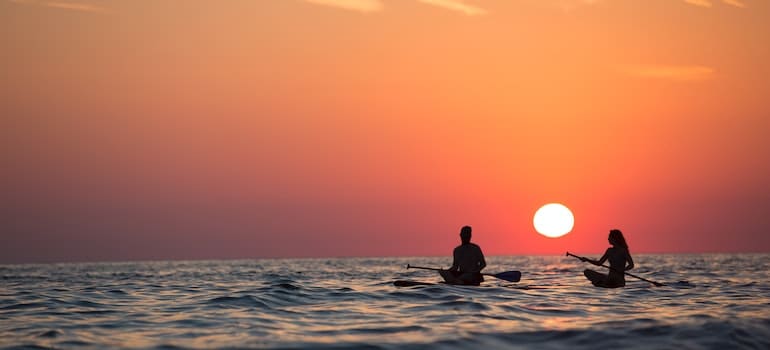 A couple paddleboarding