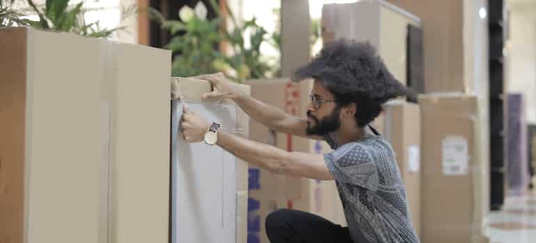 A man preparing moving boxes for relocation