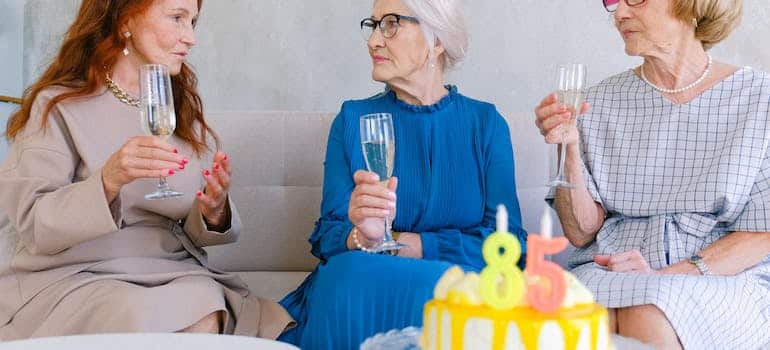 Three senior women celebrating birthday