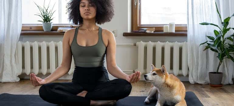 A woman meditating before moving to Boca Raton