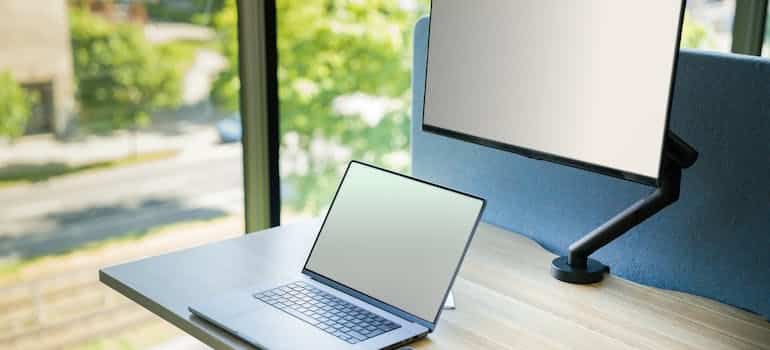 Laptop and a screen on the table