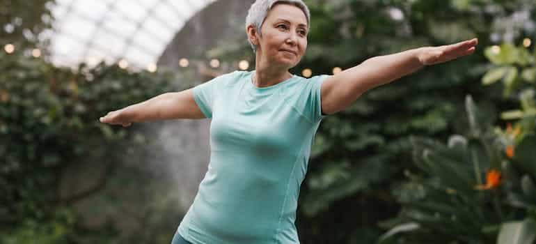 A woman doing yoga in one of the senior friendly communities in Broward County