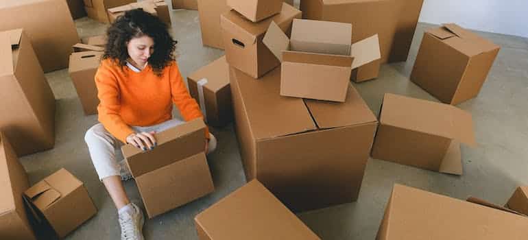 A woman packing moving boxes for a local relocation in Florida