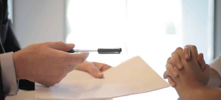 A person giving moving insurance contract to another person 