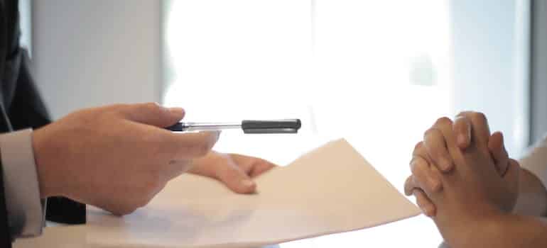 A man holding a pen and a paper