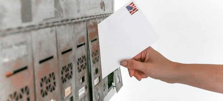 A person holding a white envelope