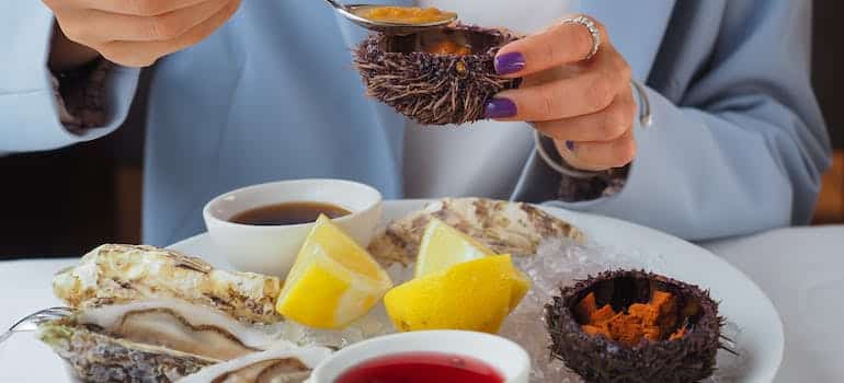 A person eating seafood after settling in Fort Lauderdale