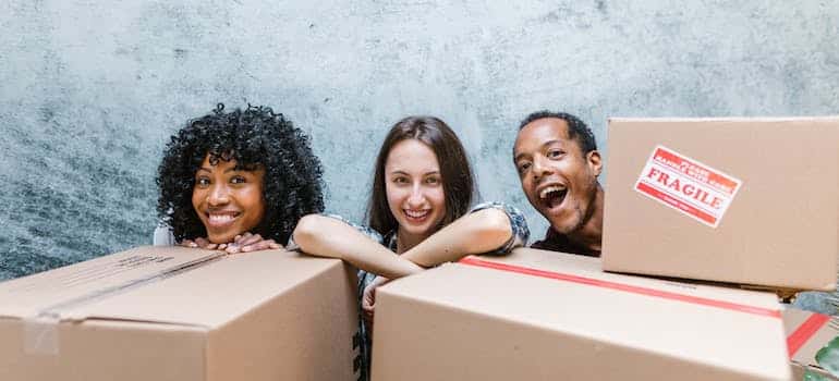 Three people ready for a cross country move from Miami