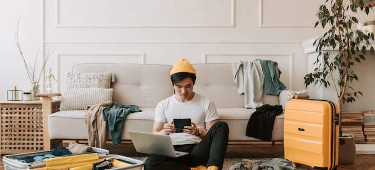 A man packing and using tablet