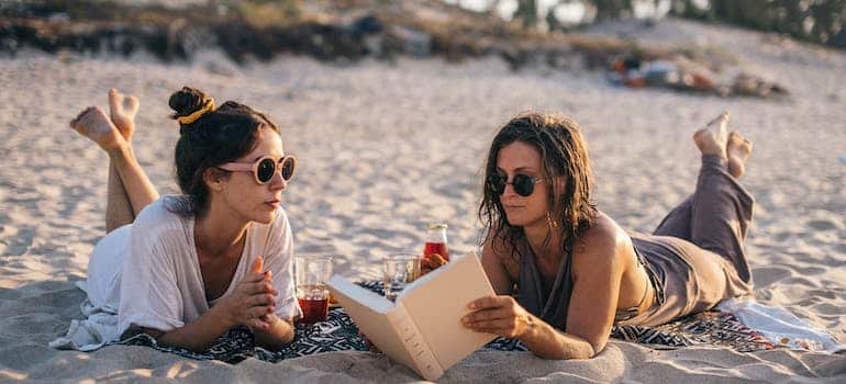 Two women styding on the beach in one of the best college towns in Florida