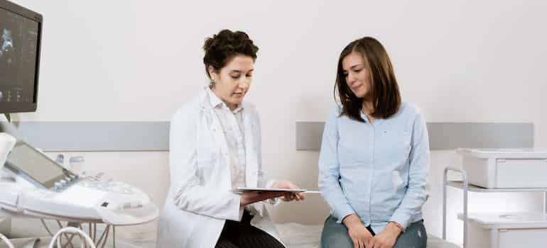 A woman talking to the doctor