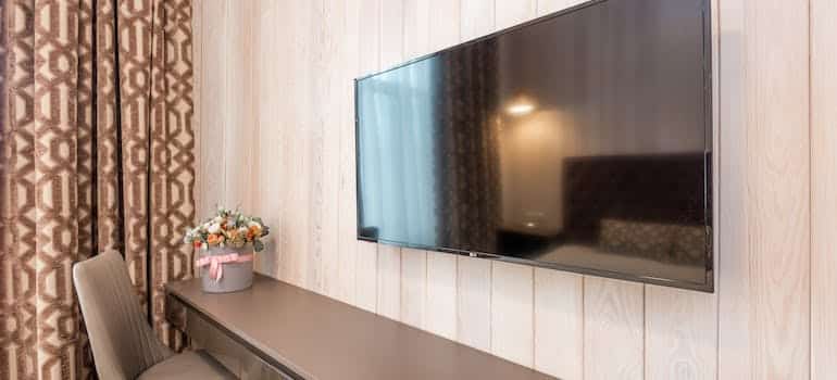 A TV on the wall of the room 