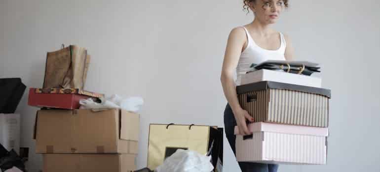 A woman decluttering and thinking how to find affordable movers in Florida