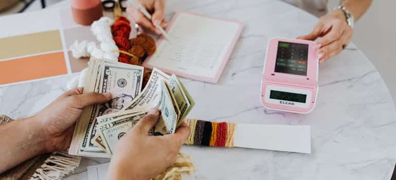 A person counting dollar bills 