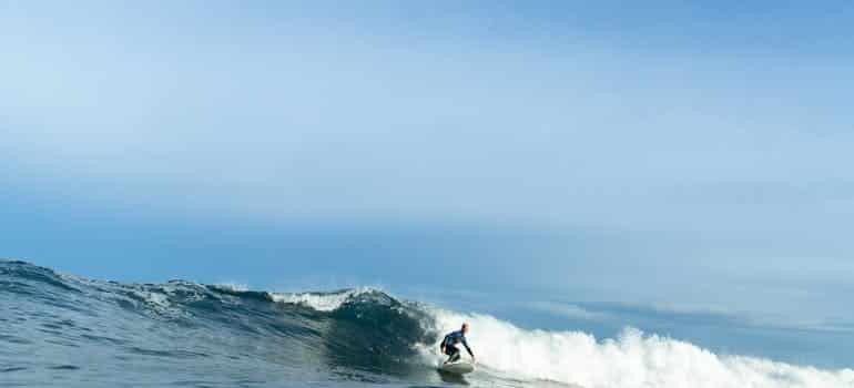 A person surfing in one of the summer break destinations in Florida